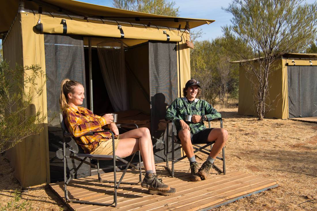 Trekkers relaxing on the porch of their campsites | <i>Shaana McNaught</i>