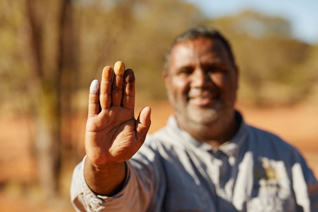 An Indigenous guide shows coloured ochres during a cultural tour |  <i>Tourism NT/Matt Cherubino</i>