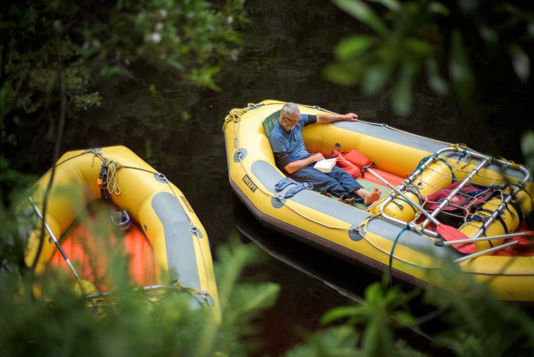 Rafter reading a book in the raft |  Glenn Walker